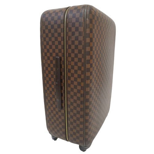 150 - A Louis Vuitton Damier Ebene Canvas Zephyr 70 Rolling Suitcase. Brown and tan monogram coated canvas... 