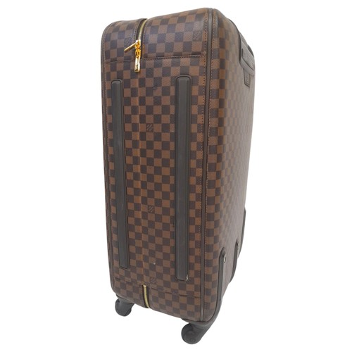 150 - A Louis Vuitton Damier Ebene Canvas Zephyr 70 Rolling Suitcase. Brown and tan monogram coated canvas... 