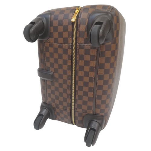 150 - A Louis Vuitton Damier Ebene Canvas Zephyr 70 Rolling Suitcase. Brown and tan monogram coated canvas... 