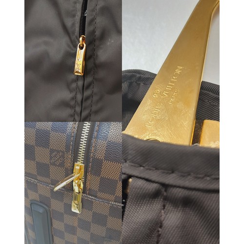 150 - A Louis Vuitton Damier Ebene Canvas Zephyr 70 Rolling Suitcase. Brown and tan monogram coated canvas... 