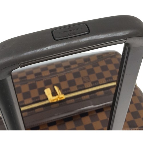 150 - A Louis Vuitton Damier Ebene Canvas Zephyr 70 Rolling Suitcase. Brown and tan monogram coated canvas... 