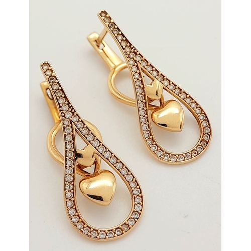 515 - A PAIR OF 14K ROSE GOLD DIAMOND EARRINGS .   3.5gms