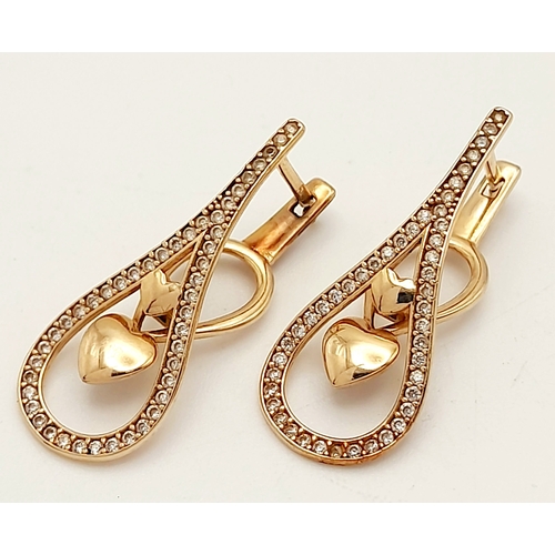 515 - A PAIR OF 14K ROSE GOLD DIAMOND EARRINGS .   3.5gms