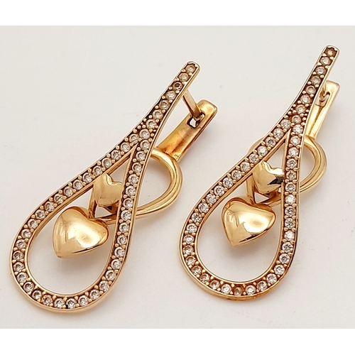 515 - A PAIR OF 14K ROSE GOLD DIAMOND EARRINGS .   3.5gms