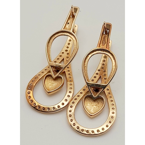 515 - A PAIR OF 14K ROSE GOLD DIAMOND EARRINGS .   3.5gms