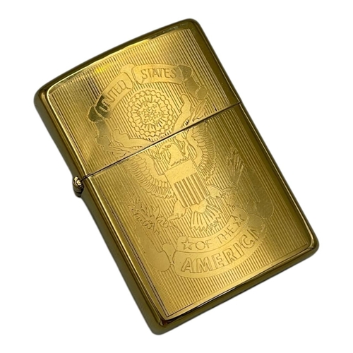 1401 - A vintage US Zippo Gold-Tone Engraved USA Emblem Lighter.
Approximately 5.5cm height x 3.5cm width. ... 