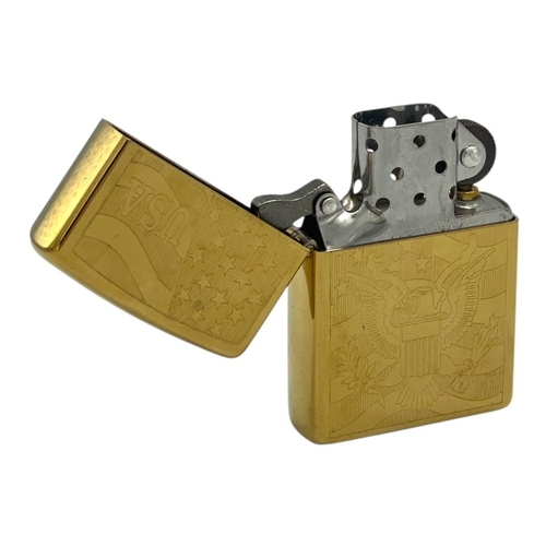 1401 - A vintage US Zippo Gold-Tone Engraved USA Emblem Lighter.
Approximately 5.5cm height x 3.5cm width. ... 