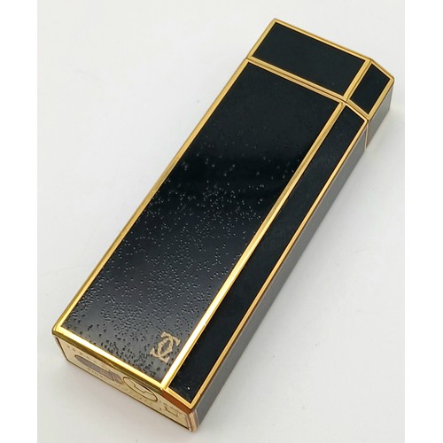 144 - A Vintage Cartier Pentagon Black Lacquer Lighter. 7cm. In working order. UK mainland sales only.