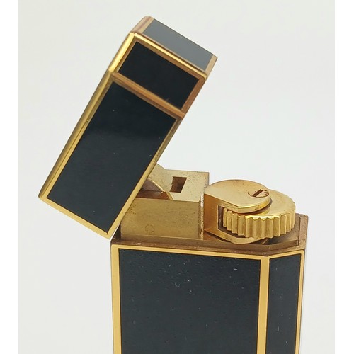 144 - A Vintage Cartier Pentagon Black Lacquer Lighter. 7cm. In working order. UK mainland sales only.