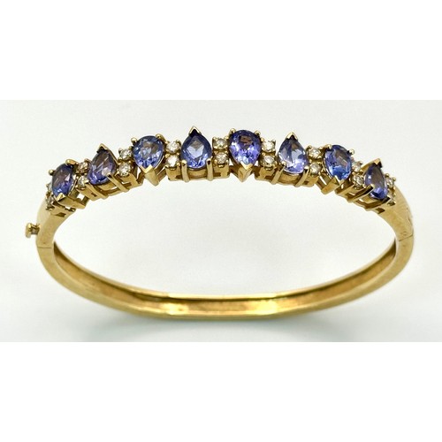 243 - A 14K GOLD HINGED DIAMONDS AND STONE SET BANGLE  .    25.4gms