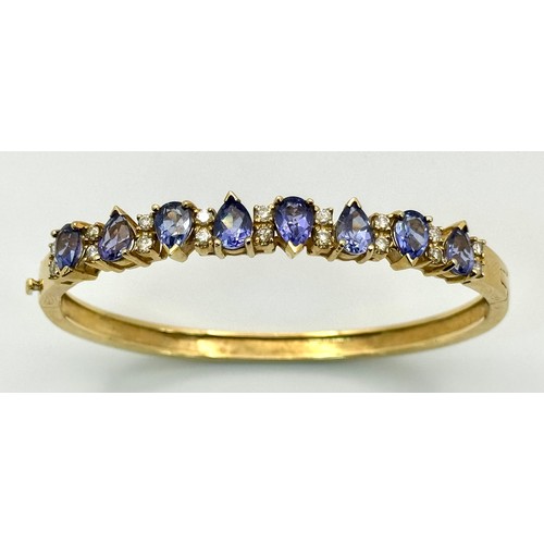 243 - A 14K GOLD HINGED DIAMONDS AND STONE SET BANGLE  .    25.4gms