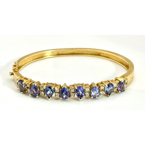 243 - A 14K GOLD HINGED DIAMONDS AND STONE SET BANGLE  .    25.4gms