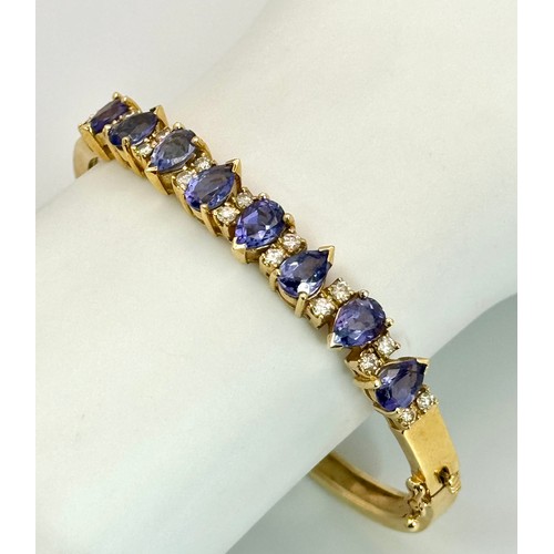 243 - A 14K GOLD HINGED DIAMONDS AND STONE SET BANGLE  .    25.4gms