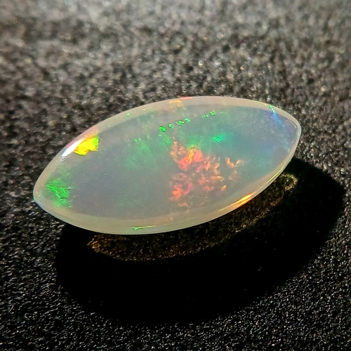 1174 - A 2.12ct Natural White Ethiopian Colourplay Opal Gemstone. Marquise shape, Cabochon cut. Comes with ... 