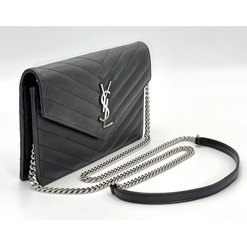 10 - A Sophisticated Yves Saint Laurent Crossbody Bag. Black leather quilted chevron exterior design. Bla... 