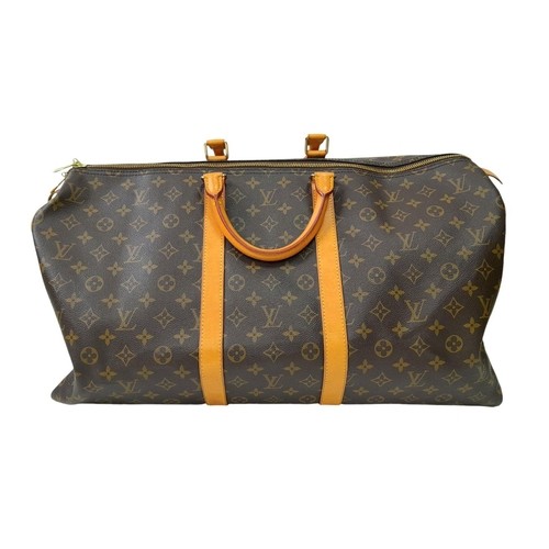 595 - A Louis Vuitton Keepall 55 Travel Bag. Monogram coated canvas exterior with leather trim, two rolled... 