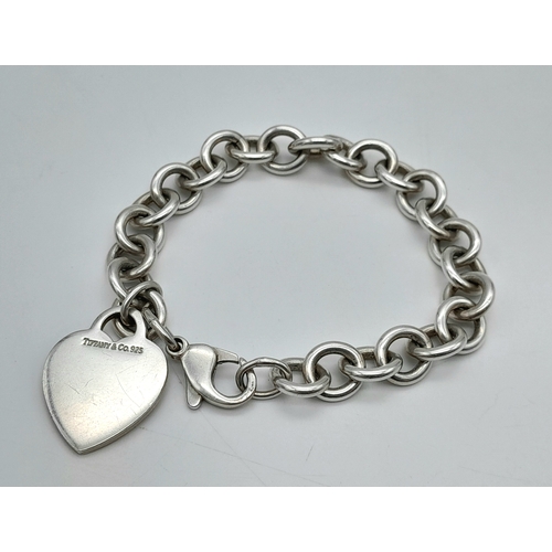 104 - A Tiffany & Co 925 Sterling Silver Circle Link Bracelet with Heart Pendant. 18cm. 35g