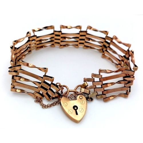 13 - A 9K Yellow Gold Gate Bracelet with Heart Clasp and Safety Chain. 18cm. 12g.