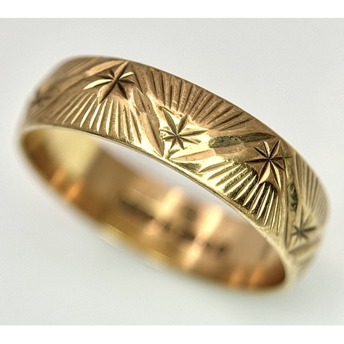 132 - A 9K Yellow Gold Decorative Band Ring. 6mm width. Size L 1/2. 2.38g. Full UK hallmarks.