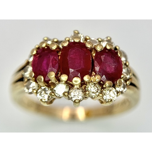 162 - A 9K Yellow Gold Ruby and Diamond Ring. Three oval cut rubies with a diamond surround. Size L. Rubie... 