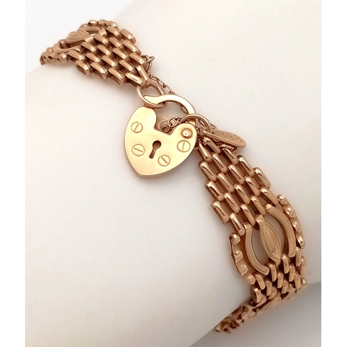 20 - A 9K Yellow Gold Fancy Gate Bracelet with Heart Clasp. 18cm. 7.7g