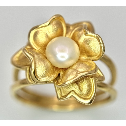 218 - A 14K Yellow Gold and Pearl Ring. Floral form. Size P 1/2. 5.85g