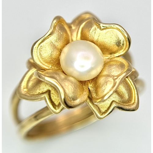 218 - A 14K Yellow Gold and Pearl Ring. Floral form. Size P 1/2. 5.85g