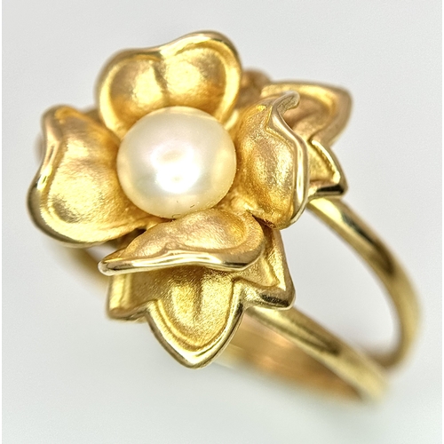 218 - A 14K Yellow Gold and Pearl Ring. Floral form. Size P 1/2. 5.85g