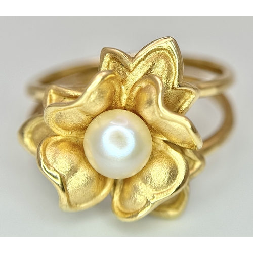 218 - A 14K Yellow Gold and Pearl Ring. Floral form. Size P 1/2. 5.85g