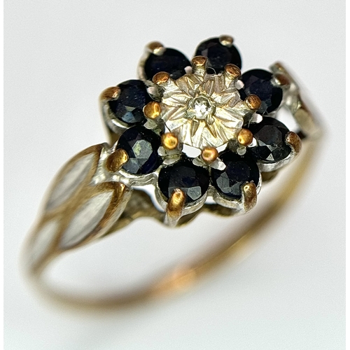 557 - A 9K Yellow Gold sapphire and Diamond Ring in Floral Form. 
Size H 1/2. 1.35g