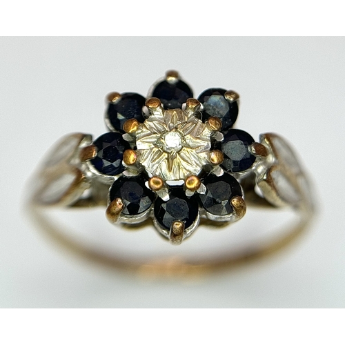 557 - A 9K Yellow Gold sapphire and Diamond Ring in Floral Form. 
Size H 1/2. 1.35g