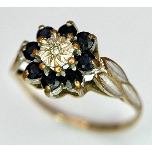 557 - A 9K Yellow Gold sapphire and Diamond Ring in Floral Form. 
Size H 1/2. 1.35g