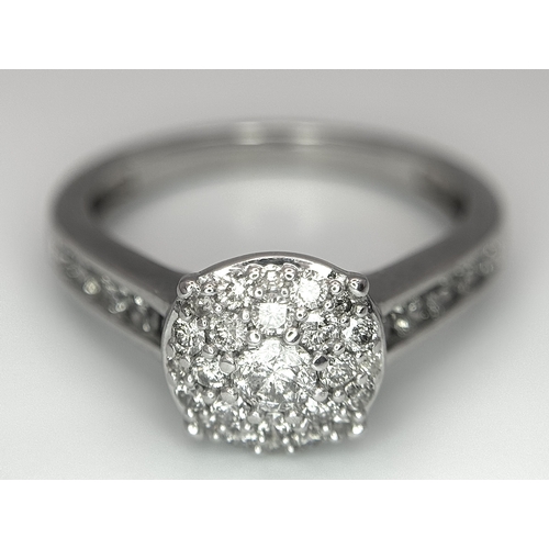 149 - AN 18K WHITE GOLD DIAMOND SET CLUSTER RING. 0.50CTW. 3.9G. SIZE N. SC5085.