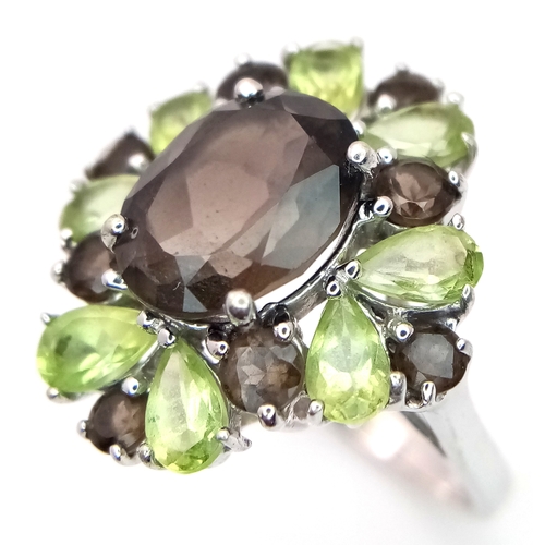 1634 - A Sterling Silver Smoky Quartz and Peridot Set Ring Size M1/2. The Ring measures 2cm Long at the Cro... 