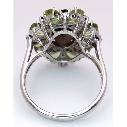 1634 - A Sterling Silver Smoky Quartz and Peridot Set Ring Size M1/2. The Ring measures 2cm Long at the Cro... 