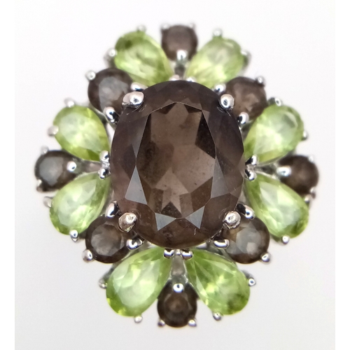 1634 - A Sterling Silver Smoky Quartz and Peridot Set Ring Size M1/2. The Ring measures 2cm Long at the Cro... 