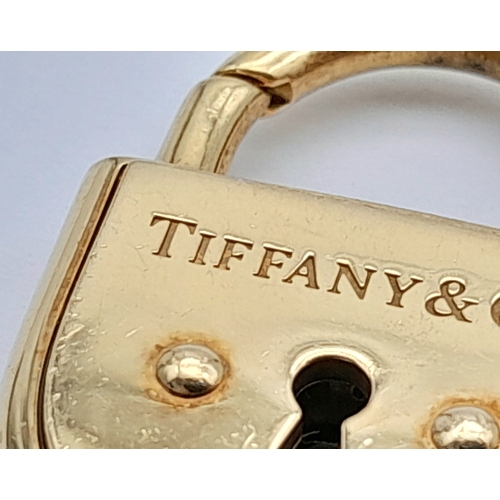 12 - A TIFFANY & CO 18K YELLOW GOLD PADLOCK PENDANT. 16G.  3CM. REF:TAN4004.