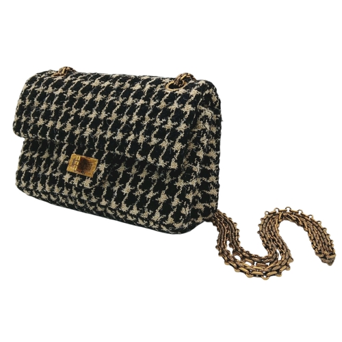 46 - A Chanel Black and Cream Houndstooth Tweed Flap Bag. Black and cream tweed exterior with gold-toned ... 