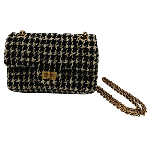 46 - A Chanel Black and Cream Houndstooth Tweed Flap Bag. Black and cream tweed exterior with gold-toned ... 