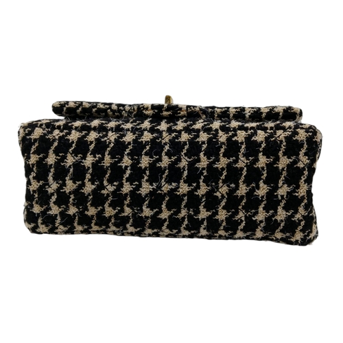 46 - A Chanel Black and Cream Houndstooth Tweed Flap Bag. Black and cream tweed exterior with gold-toned ... 