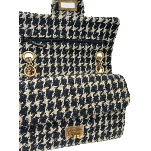 46 - A Chanel Black and Cream Houndstooth Tweed Flap Bag. Black and cream tweed exterior with gold-toned ... 