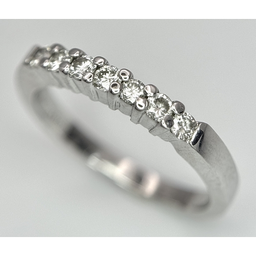 128 - AN 18K WHITE GOLD DIAMOND SET HALF ETERNITY RING 0.28CT , 3.5G TOTAL WEIGHT, SIZE N. Ref: SC 4047