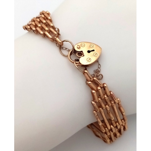 163 - A 9K GOLD VINTAGE 9 GATE BRACELET WITH HEART PADLOCK AND SAFETY CHAIN. A/F. 11.4gms