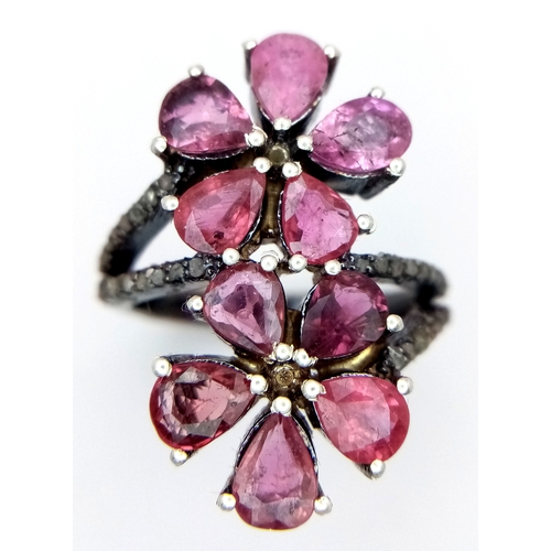 180 - A Ruby and Old Cut Diamond Flower-Form Ring. Set in 925 Silver. Ruby weight approx 3ctw. Diamonds 0.... 