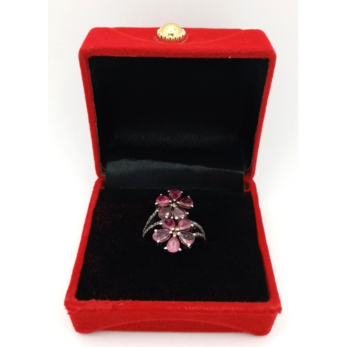 180 - A Ruby and Old Cut Diamond Flower-Form Ring. Set in 925 Silver. Ruby weight approx 3ctw. Diamonds 0.... 