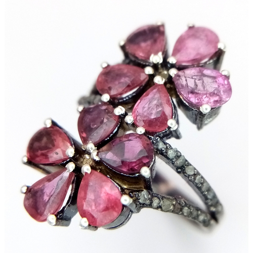 180 - A Ruby and Old Cut Diamond Flower-Form Ring. Set in 925 Silver. Ruby weight approx 3ctw. Diamonds 0.... 