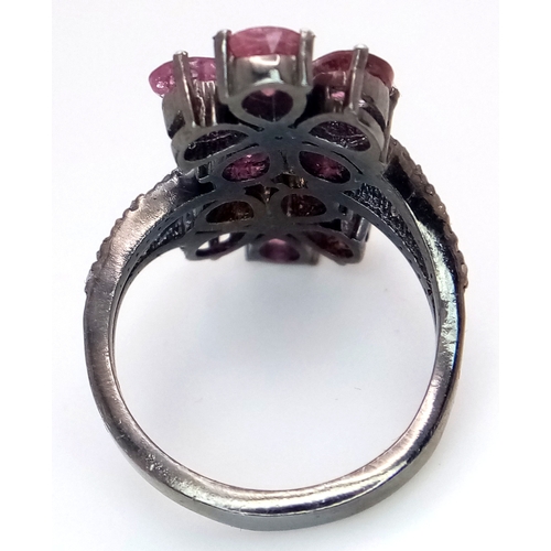 180 - A Ruby and Old Cut Diamond Flower-Form Ring. Set in 925 Silver. Ruby weight approx 3ctw. Diamonds 0.... 