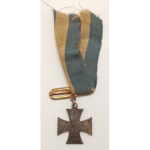 428 - A Miniature 1914 Iron Cross. Hangs from a blue and white ribbon. Some wear. Magnetic core.