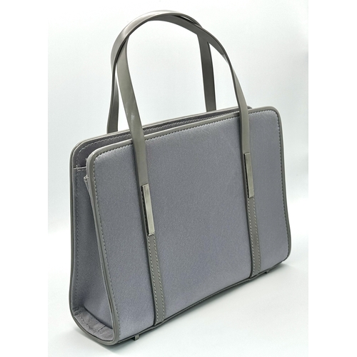 508 - A Small Gucci Grey Satin and Leather Handbag. Silver tone hardware. 16cm height. 21cm length. Textil... 