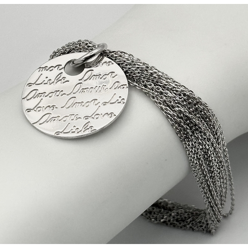 516 - A STERLING SILVER MULTI STRAND BRACELET WITH CHARM - ENGRAVED WITH THE WORD LOVE IN MANY LANGUAGES 1... 